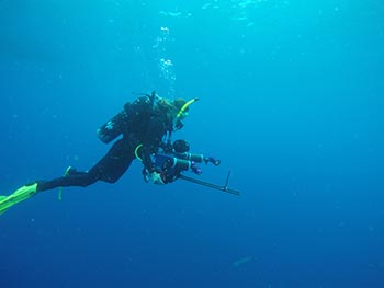 Scuba diver with data-collection equipment