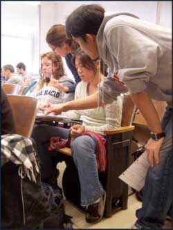 Figure 1: Undergraduate Teaching Assistants (UGAs) work with students in an introductory lecture.