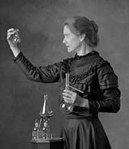 The actor Susan Marie Frontczak in period dress posing as Madame Marie Curie.